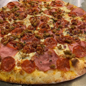 pizza with canadian bacon that comes from pork tenderloin zeeks has specially made by Compart Farms