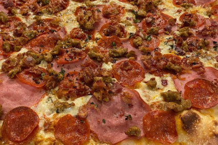 pizza with canadian bacon that comes from pork tenderloin zeeks has specially made by Compart Farms